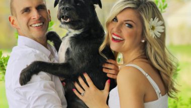 couple holding dog